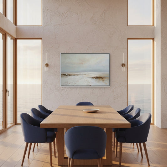 Modern dining room with wooden table and blue chairs, featuring a framed landscape painting on the wall.