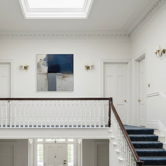 Staircase with white walls and a painting in a formal setting