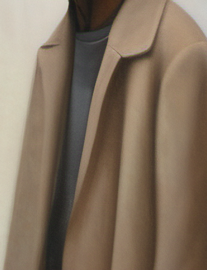 Close-up of a brown coat with a neutral background