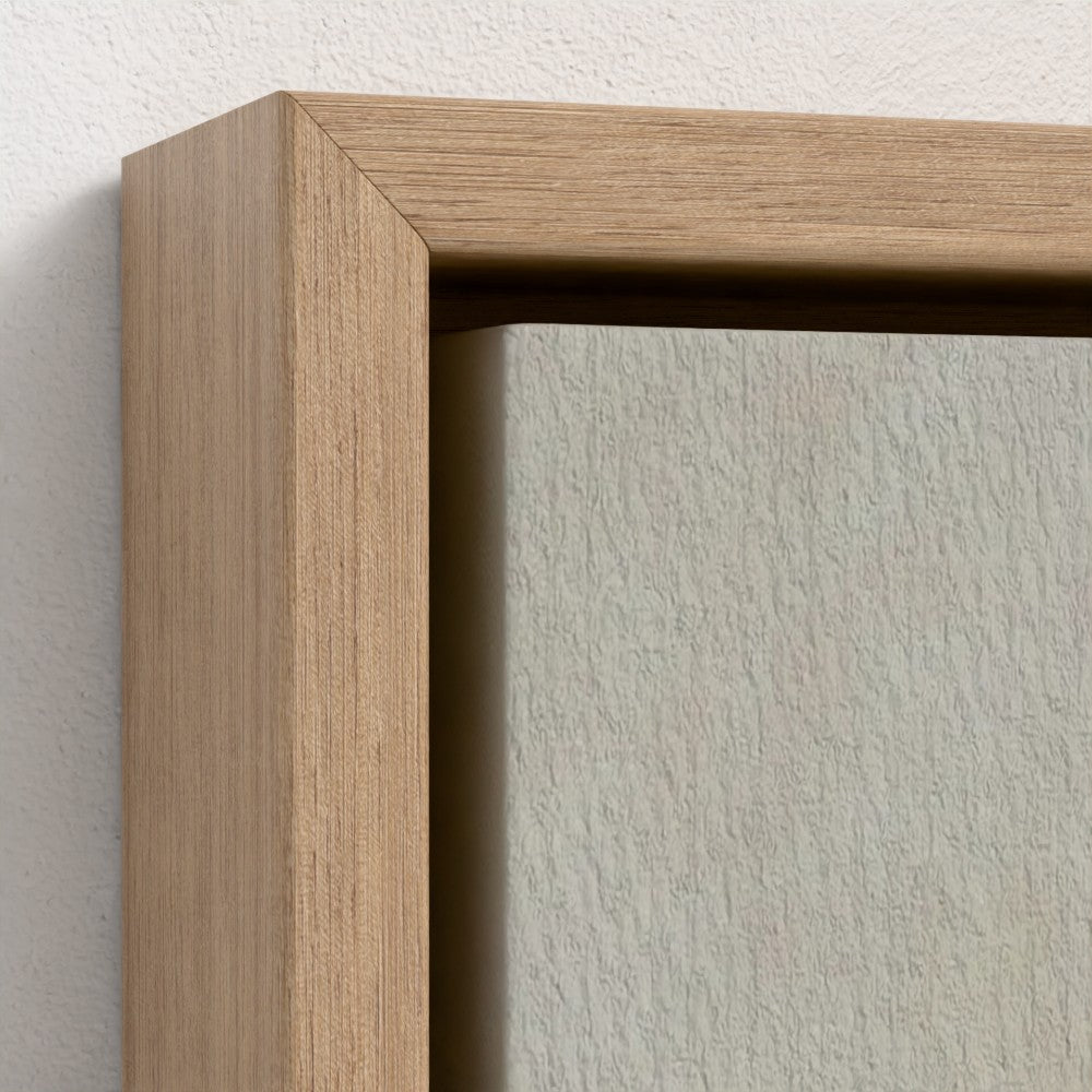 Close-up of a wooden picture frame on a textured wall.