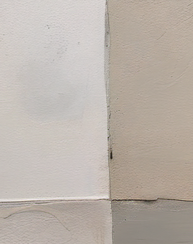 Close-up of textured wall with different shades of gray.