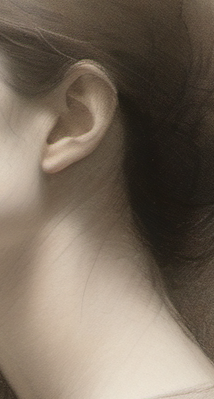 Close-up of a person's ear and shoulder with soft focus