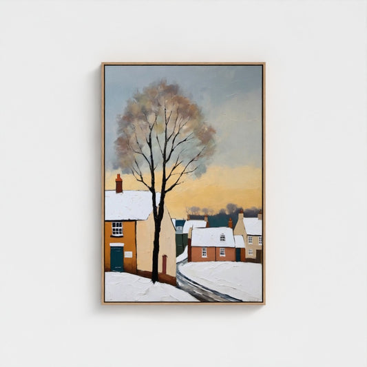 Framed artwork of a snowy village scene with a tree on a white wall