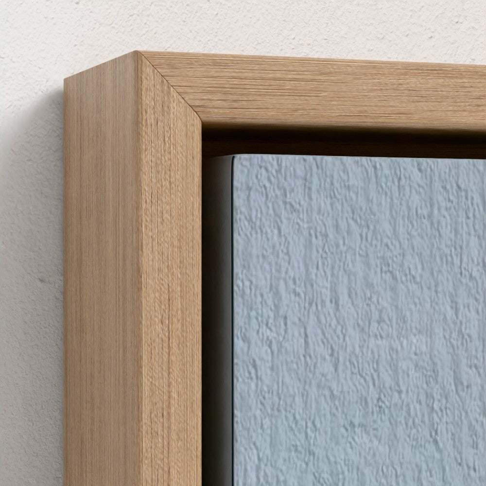 Close-up of a wooden picture frame with a light blue wall background