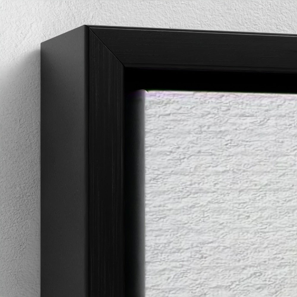 Close-up of a black picture frame on a textured white wall.