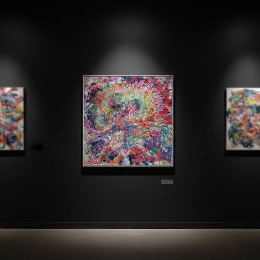 Colorful abstract painting on a dark wall with spotlight effect