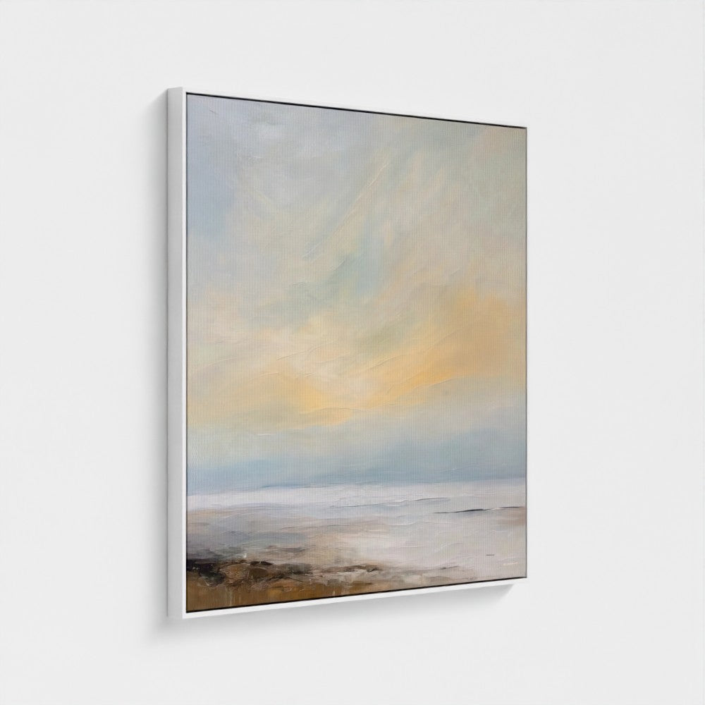 Framed artwork of a landscape with a rainbow over water on a white wall.