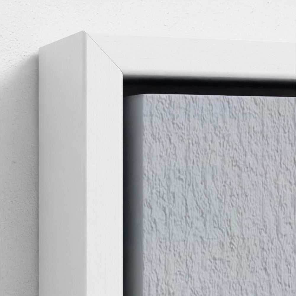 Close-up of a white frame corner on a textured white wall