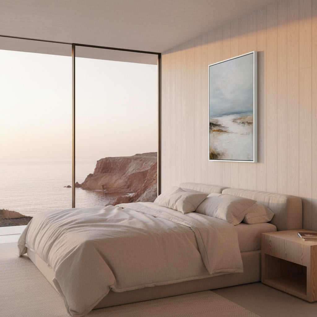 Modern bedroom with a large bed, side table, and wall art.