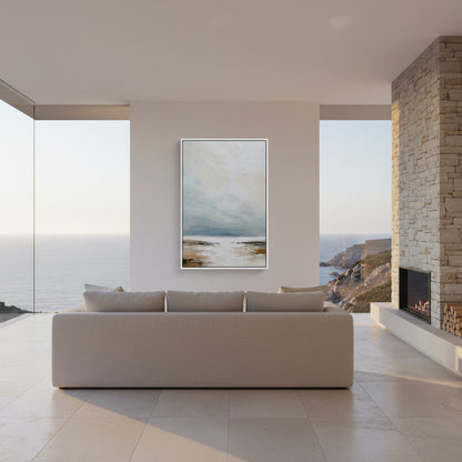 Modern living room with a sofa, abstract painting, and fireplace overlooking a scenic view.