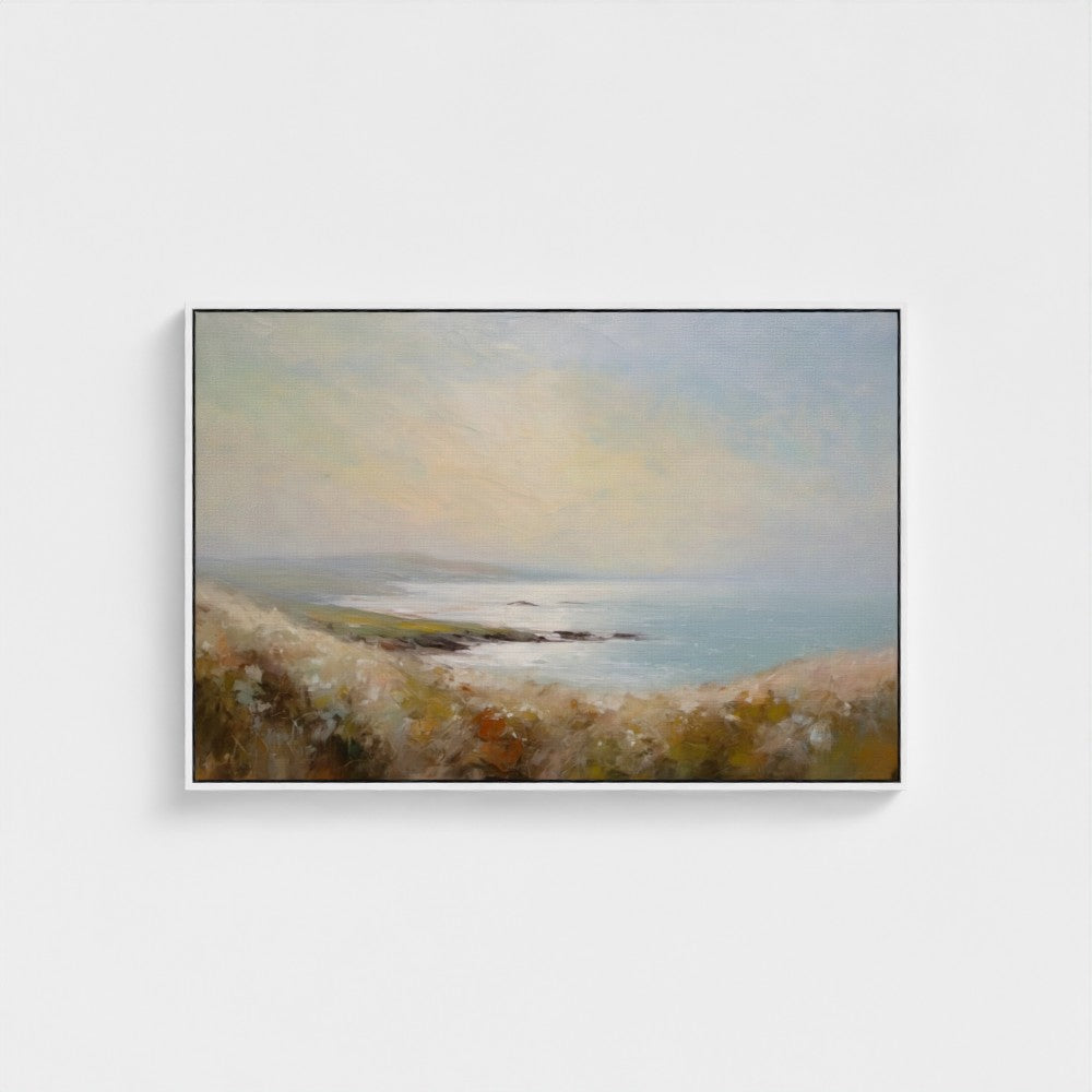 Framed painting of a landscape with a body of water and grassy area on a white wall.