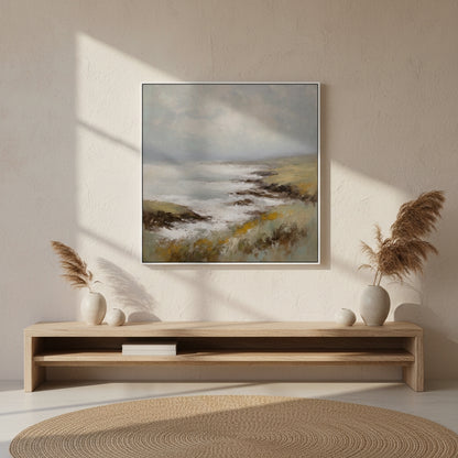 Framed landscape painting on a wall above a wooden console table with decorative items.