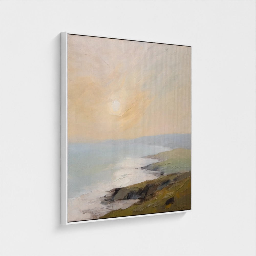 Framed artwork of a landscape with a sunset over a coastal scene.