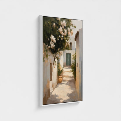 Framed artwork of a sunlit alley with flowers and white walls.