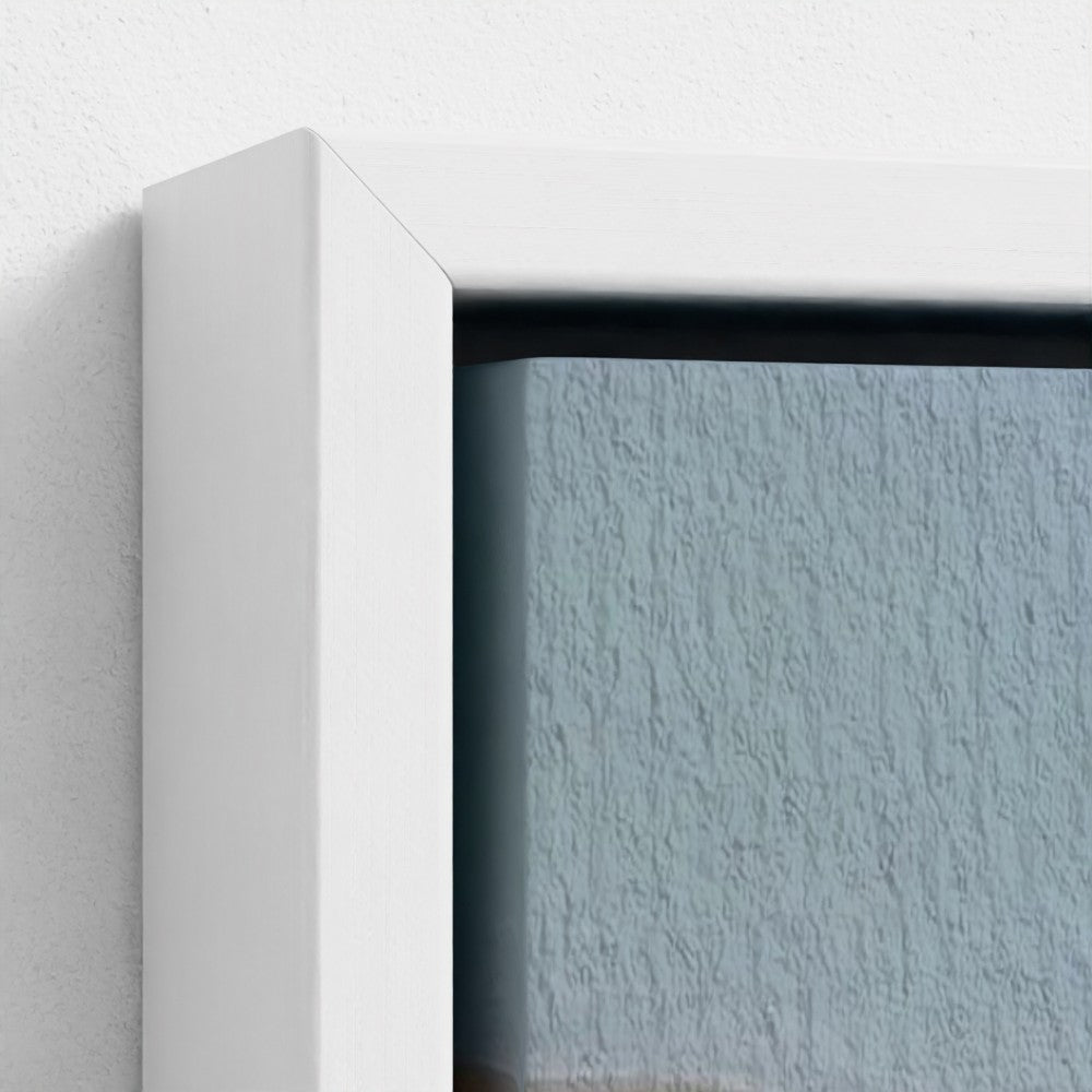 Close-up of a white frame corner with a textured blue wall background