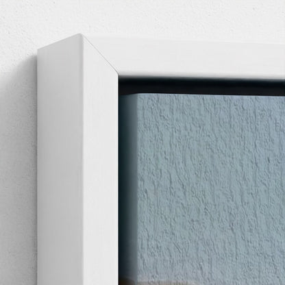 Close-up of a white frame corner with a textured blue wall background