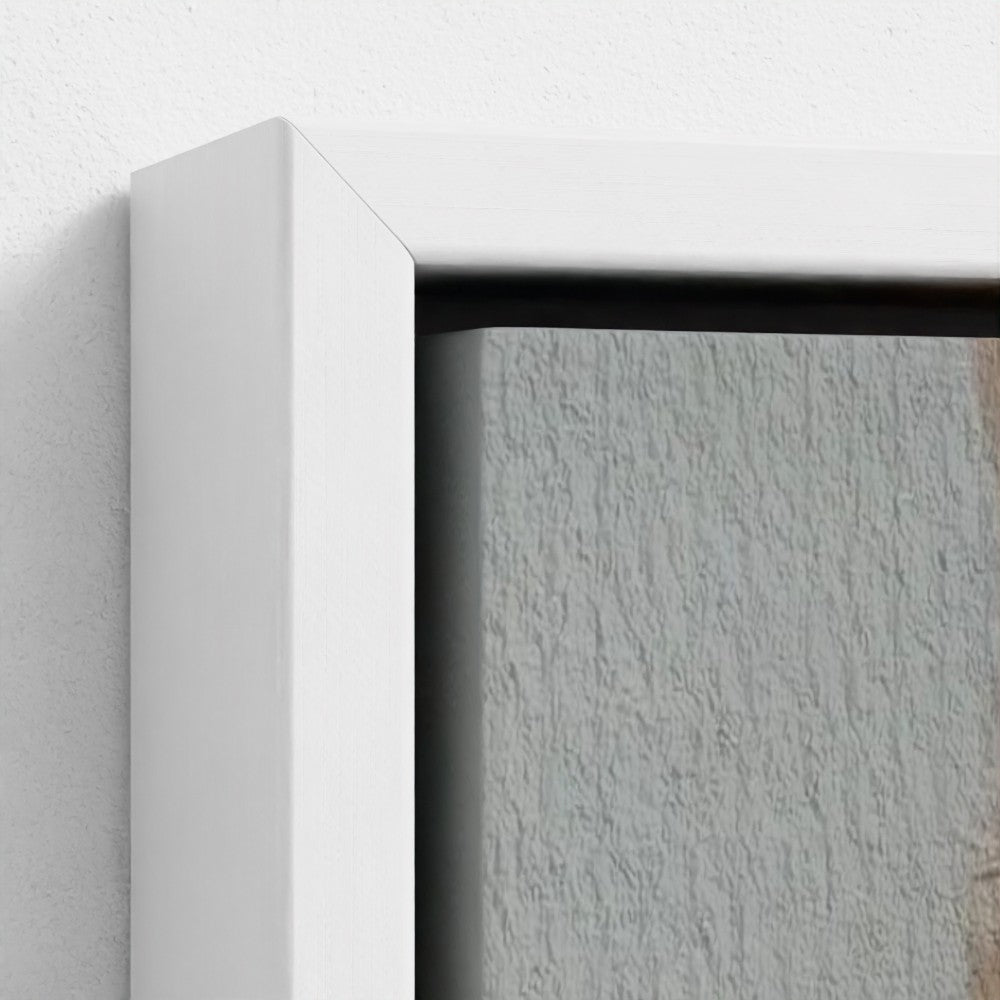 Close-up of a white picture frame corner on a textured wall.
