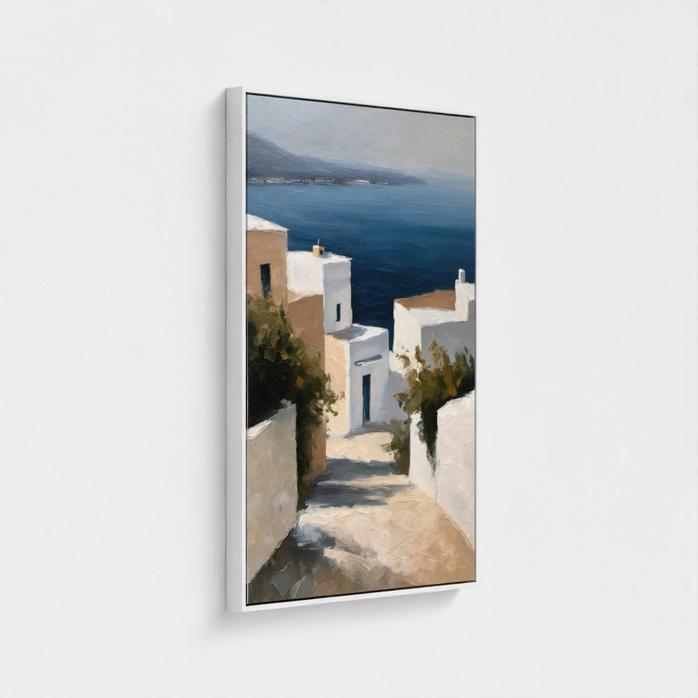 Framed artwork of a coastal scene with white buildings and blue sea.