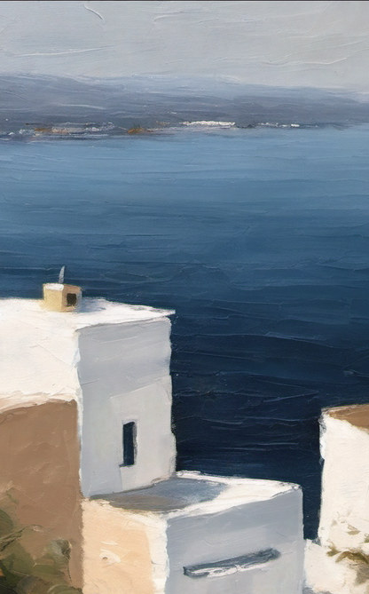 White building with a blue sea and mountains in the background