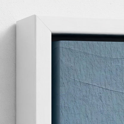 Close-up of a white frame corner with a textured blue wall background