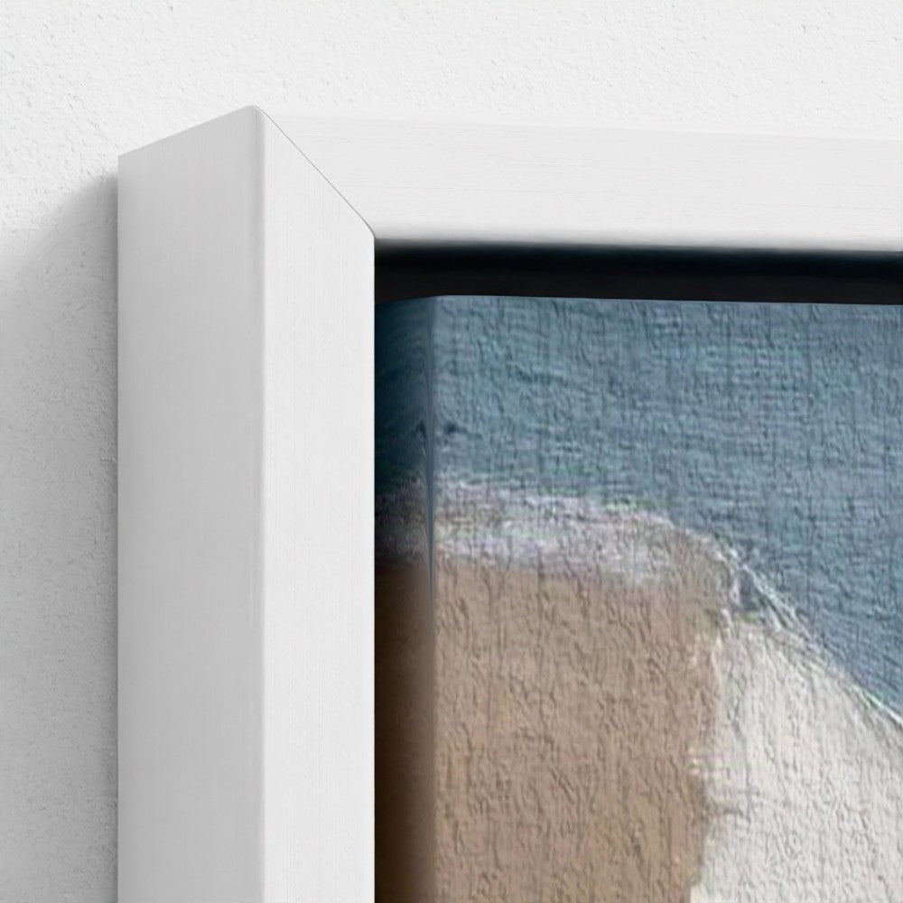 Framed artwork of a beach scene with waves and sand.