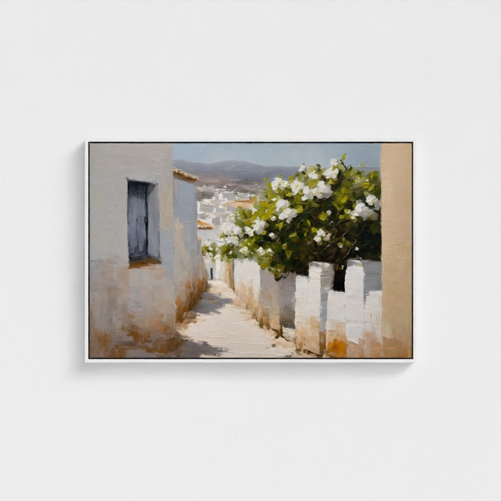 Framed artwork of a white-washed building with a flower bush on a white wall