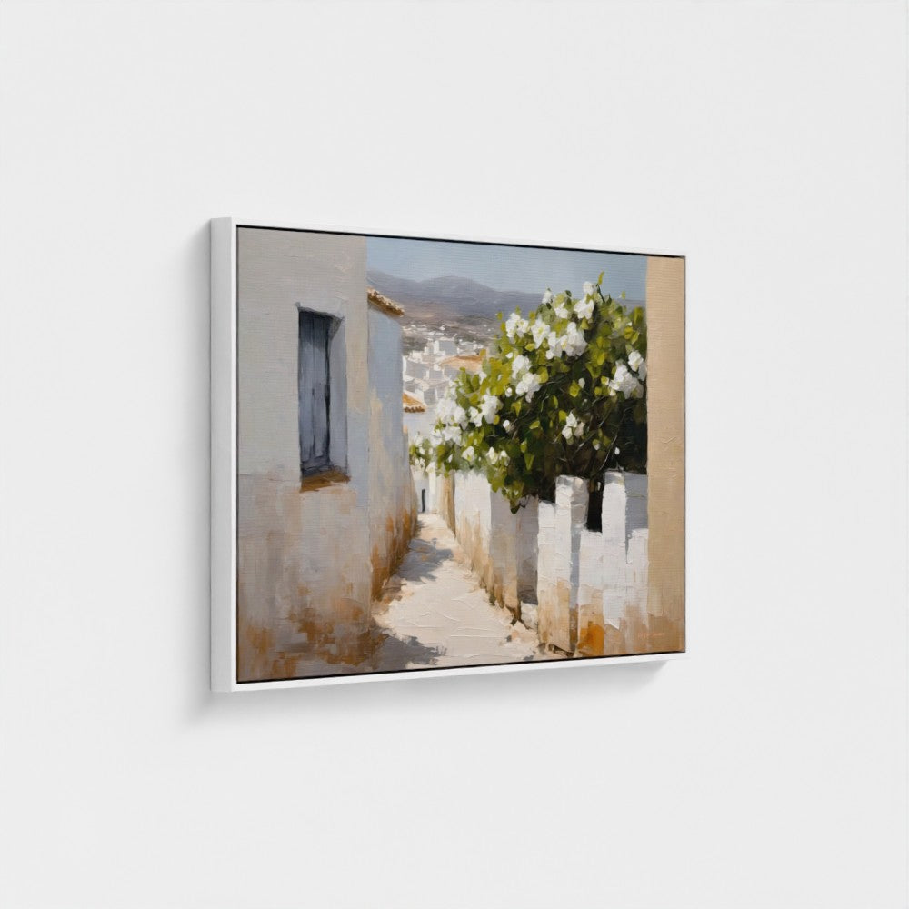 Framed artwork of a scenic view with a building and flowers on a white wall