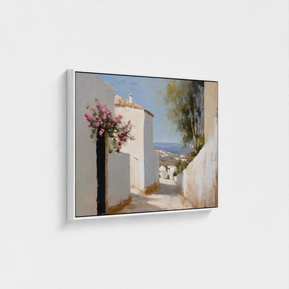 Framed artwork of a scenic coastal village with flowers on a white wall