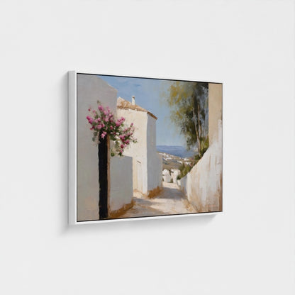 Framed artwork of a scenic coastal village with flowers on a white wall