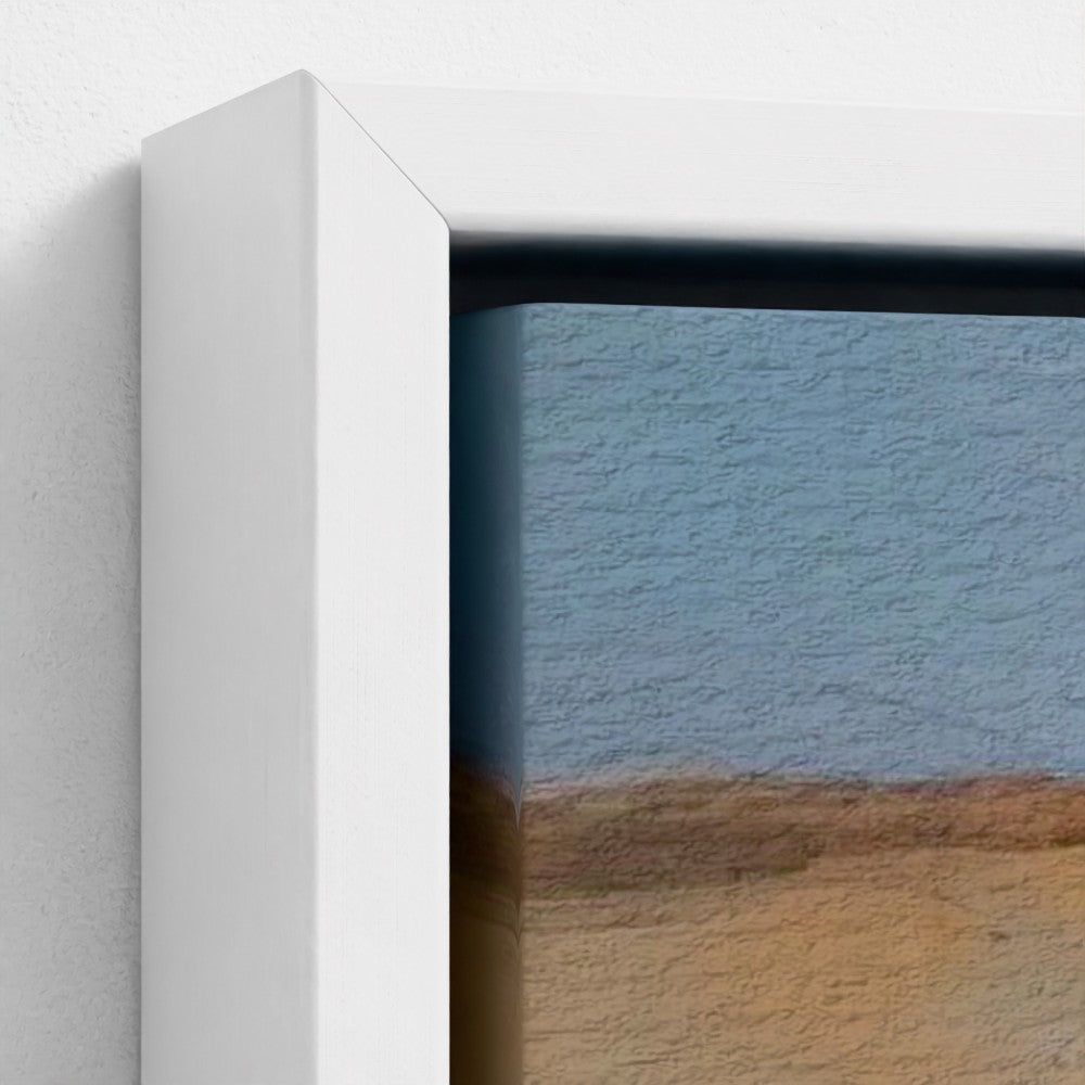 Framed artwork of a landscape with a blue sky and brown earth.