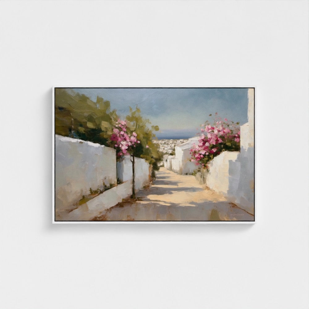 Framed artwork of a scenic street with white walls and pink flowers on a white background