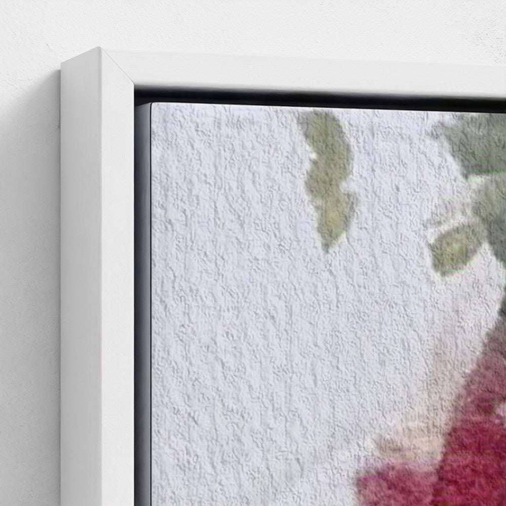 Close-up of a framed artwork with a textured white background and green leaves.