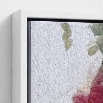 Close-up of a framed artwork with a textured white background and green leaves.