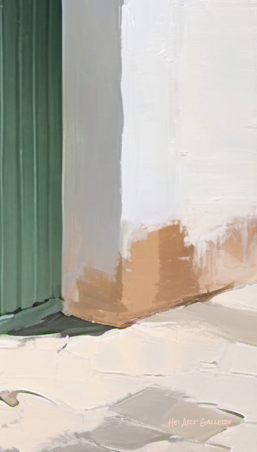Close-up of a corner with a green baseboard and white wall.