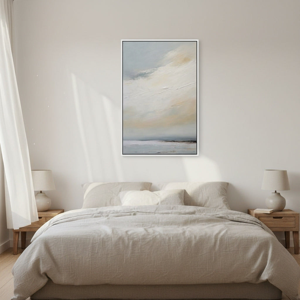 Bedroom with abstract art on the wall, two lamps, and a bed.