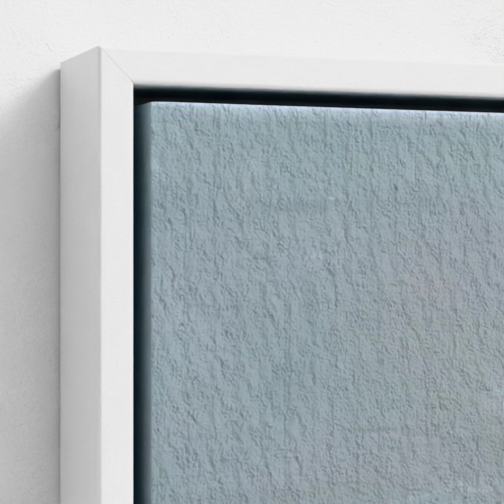 Close-up of a textured blue wall with a white frame.