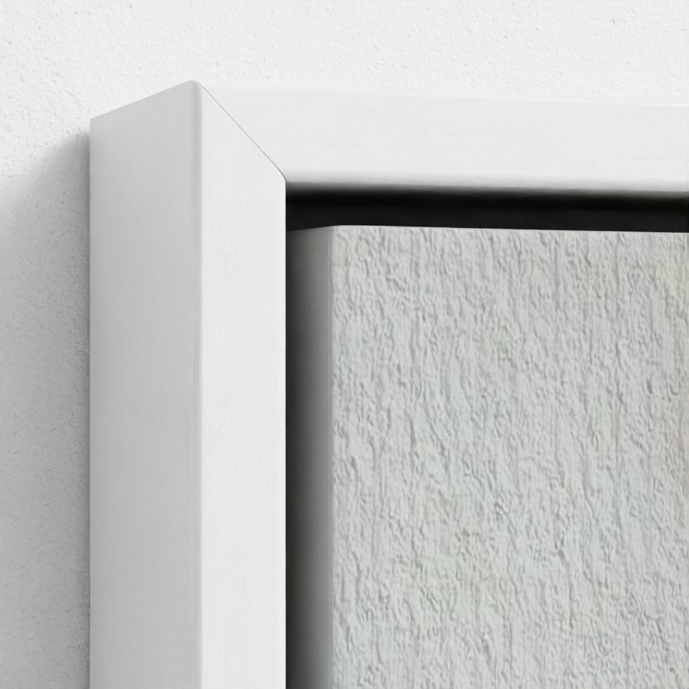 Close-up of a white frame corner on a textured white surface