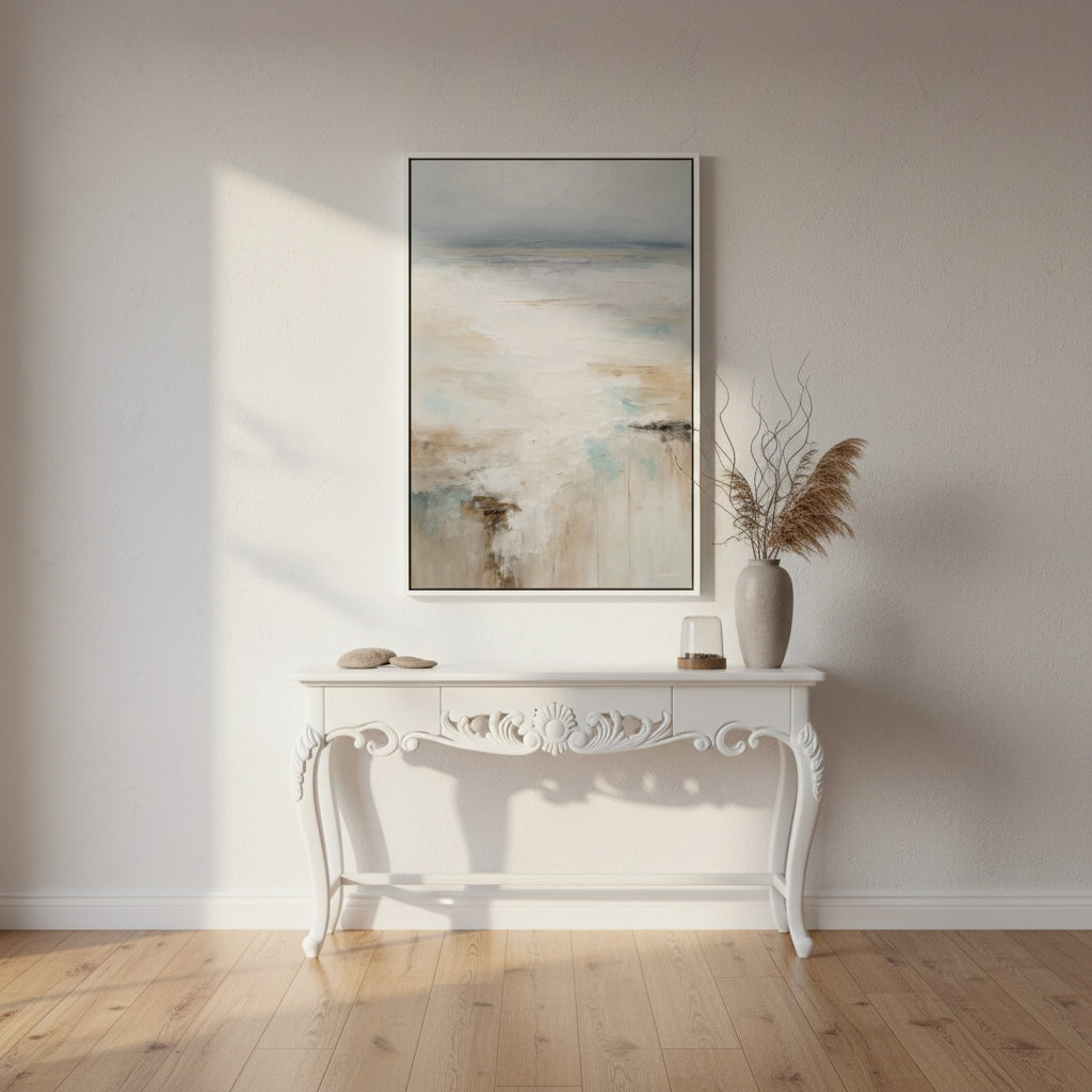 Decorative console table with a vase and abstract painting in a room with wooden flooring.