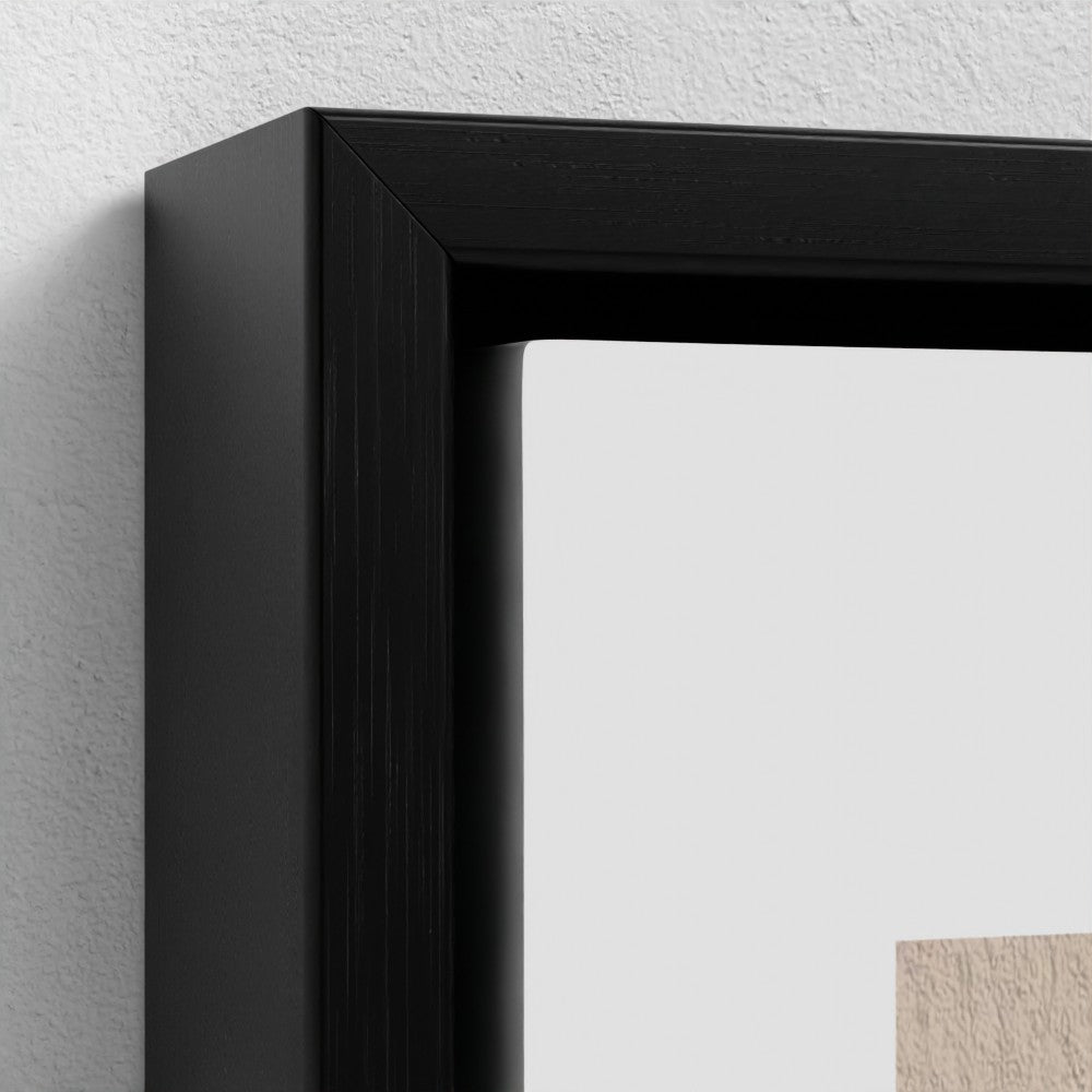 Close-up of a black picture frame on a light gray wall.