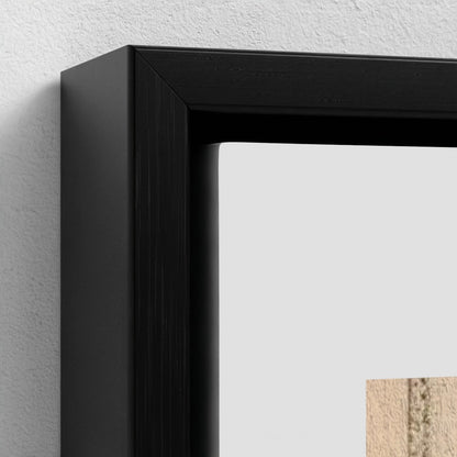 Close-up of a black picture frame on a light gray wall.