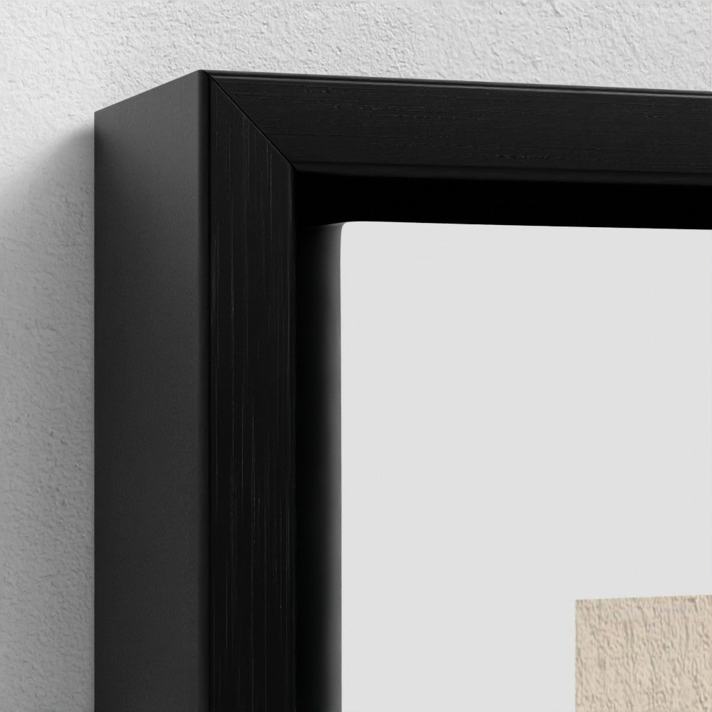 Close-up of a black picture frame on a light gray wall.