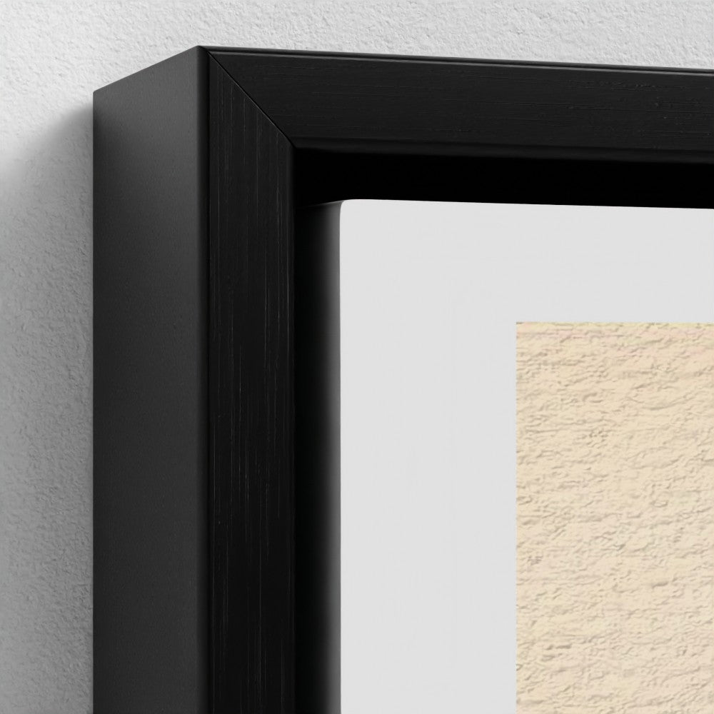 Close-up of a black framed picture on a textured wall.