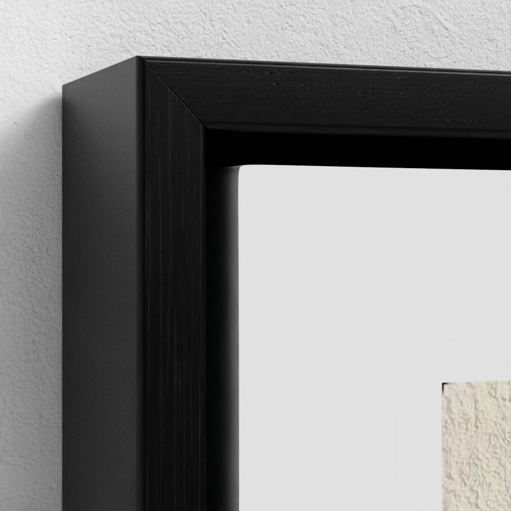 Close-up of a black picture frame on a white wall.