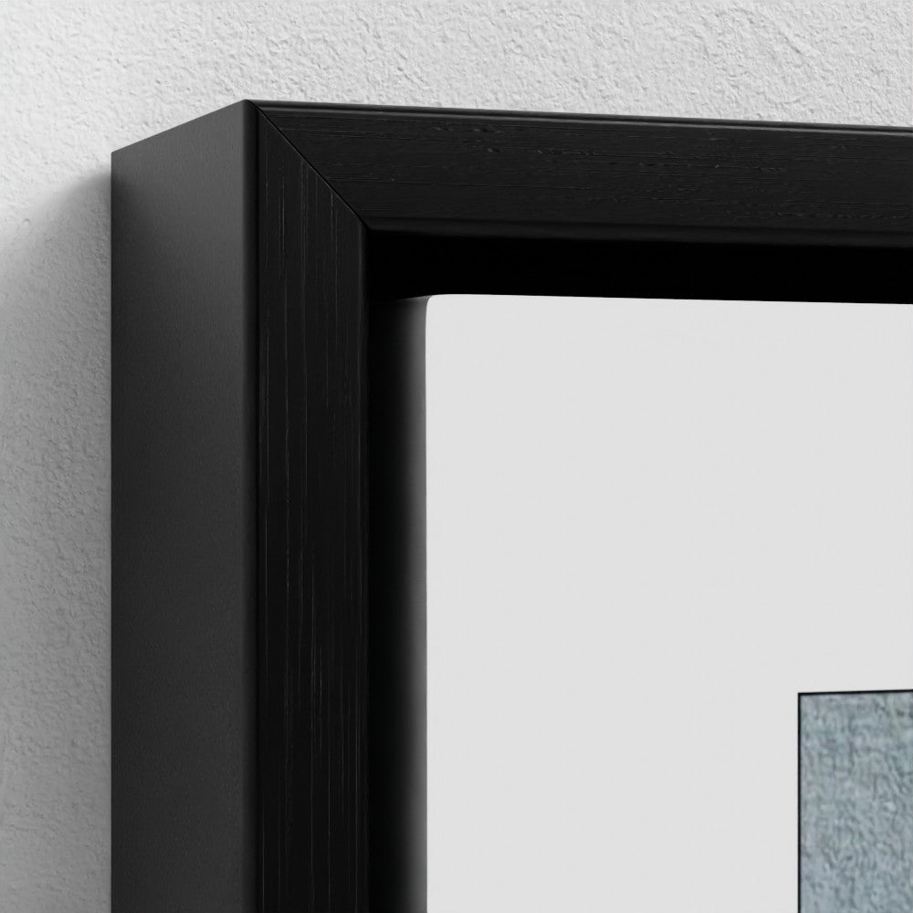 Close-up of a black picture frame on a white wall