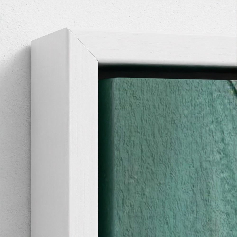 Close-up of a textured green wall with a white frame.