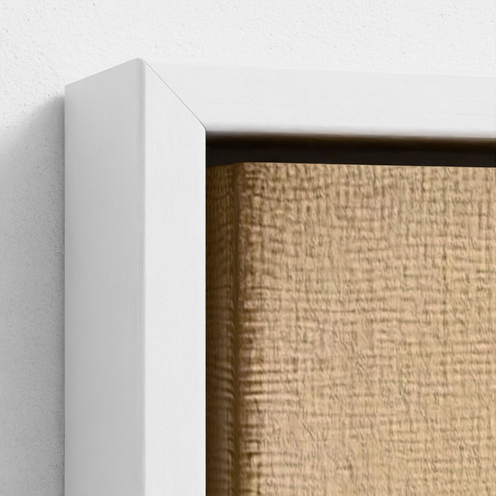 Close-up of a textured beige wall with a white frame.