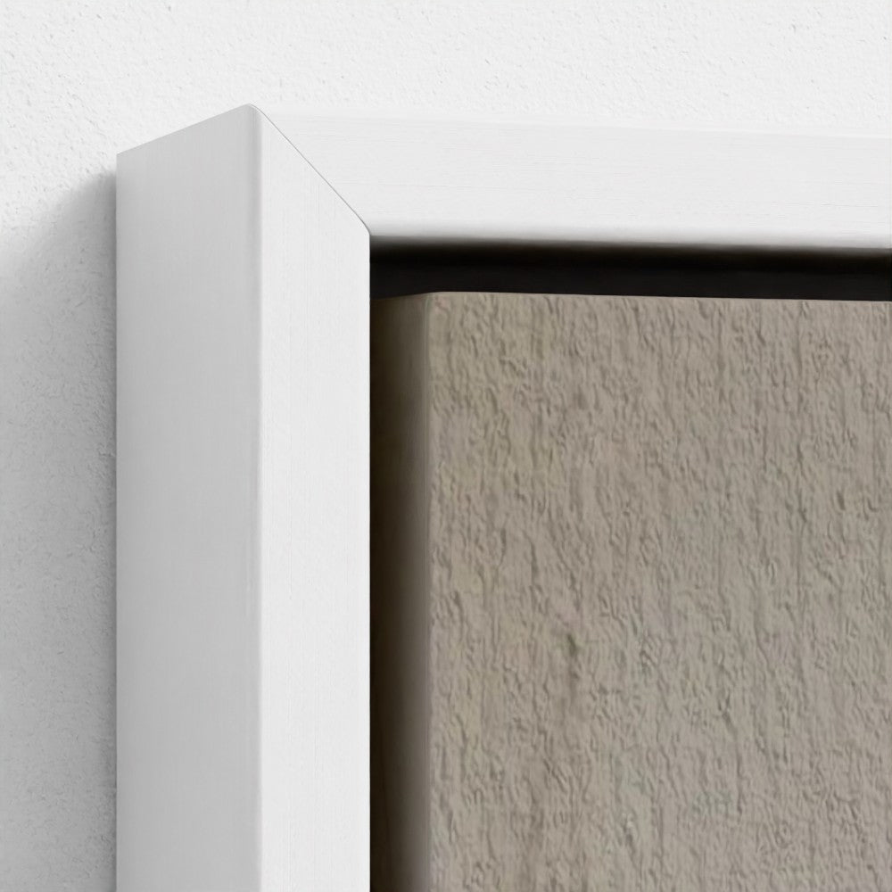 Close-up of a textured wall with a white frame.