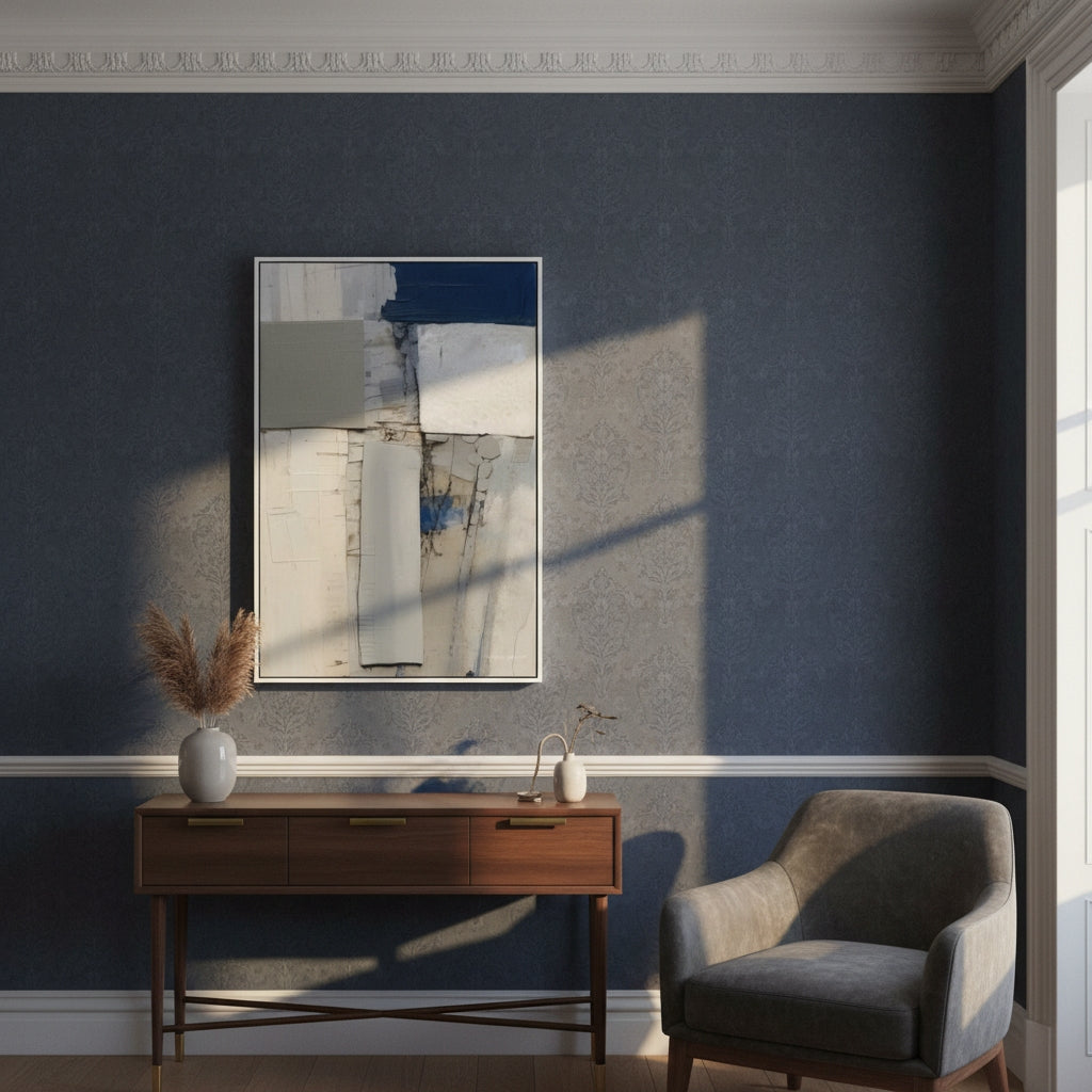 Modern interior with abstract art, console table, and chair against a dark blue wall.