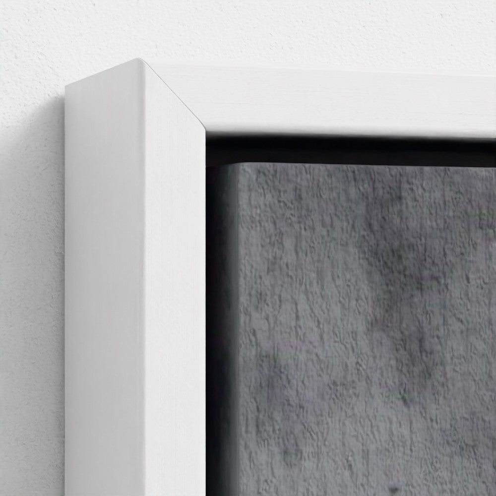 Close-up of a white frame corner with a textured gray background