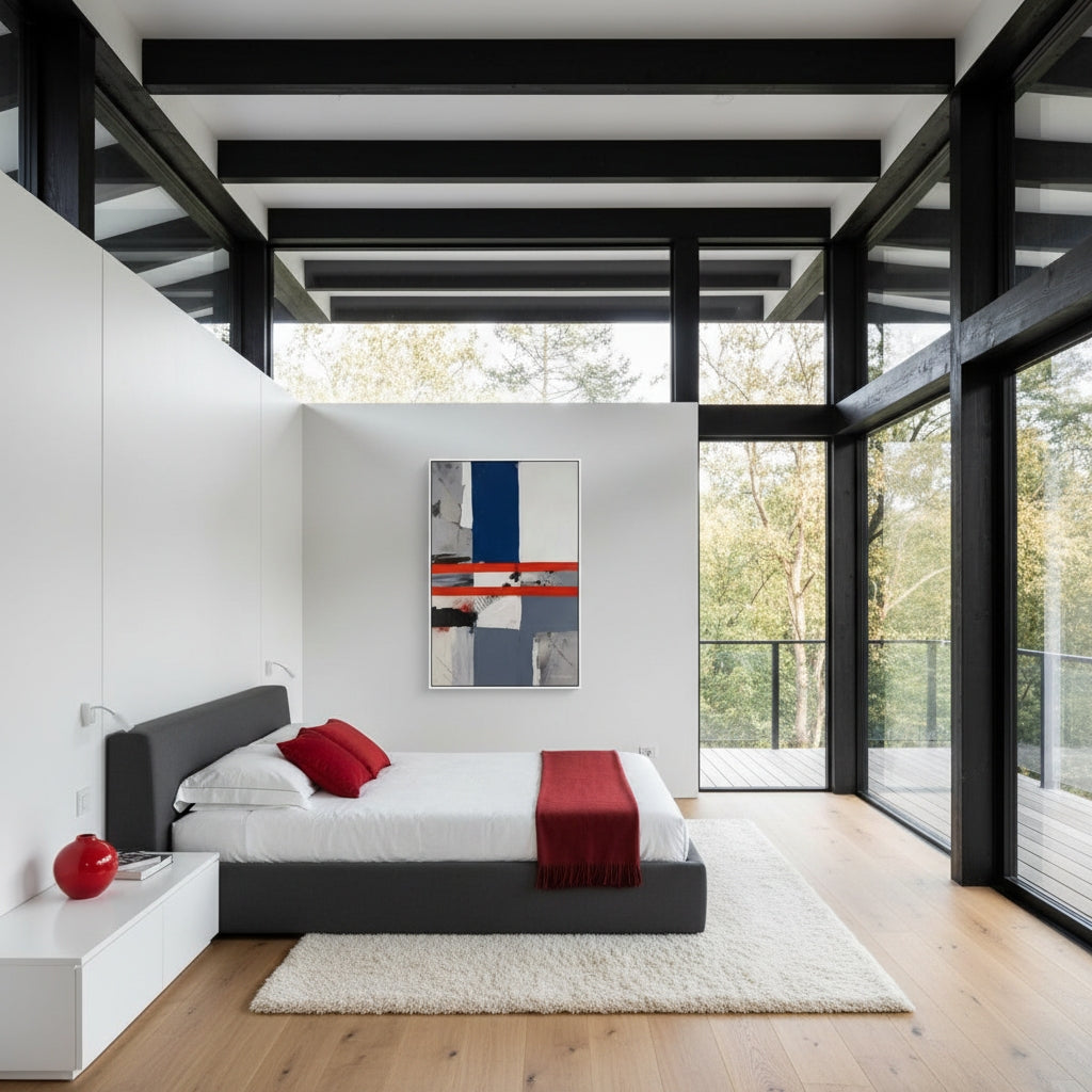 Modern bedroom with black bed frame, white bedding, red accents, and abstract art on wall.